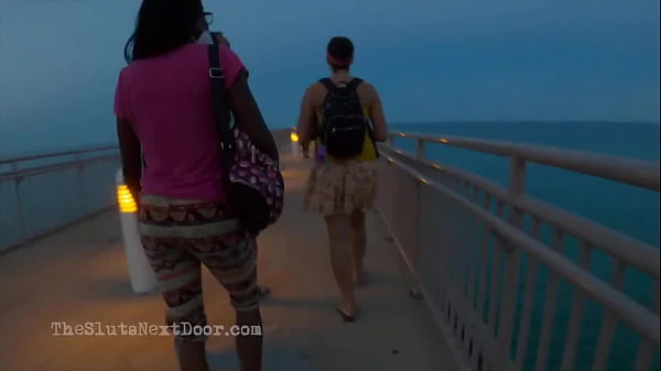 Double handjob on public beach