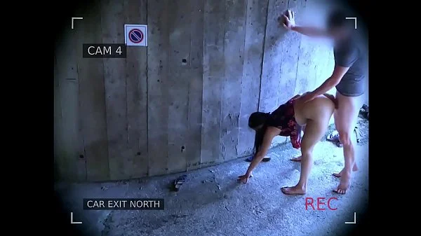 Young couple fucks in front of the garage exit and is caught by the surveillance camera