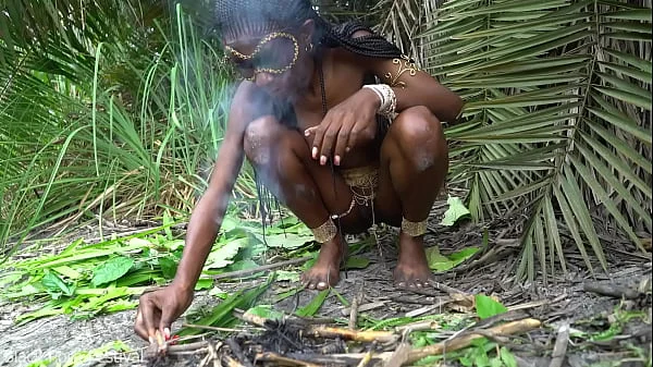 Hot African native woman cooking in the jungle
