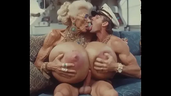 JAY7 Granny Boob Cruise 01 - AI VIDEO - A topless and horny granny with huge bolt-on tits gives a crazy titjob to the skipper