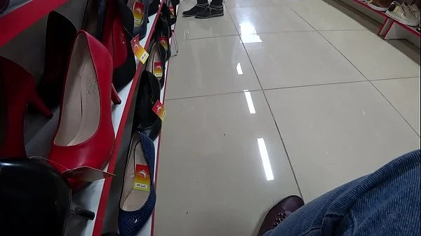 Voyeur and foot fetish in a public place. Beautiful legs in stockings and a juicy ass under a short dress in a shoe store.