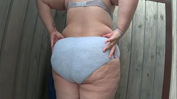 BBW with big booty in tight jeans is dressing in a public dressing room on the beach. Fetish.