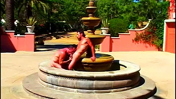 Muscle boys fucking next to a fountain