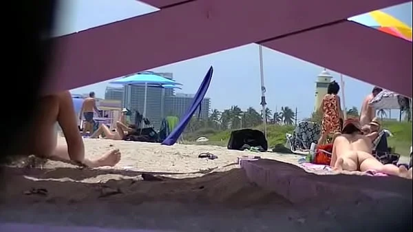 Exhibitionist Wife 63 - Tatiana teasing NUDE BEACH VOYEUR cocks while her hubby takes a nap!