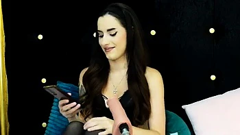 Sexy brunette babe in lingerie and stockings toys pussy