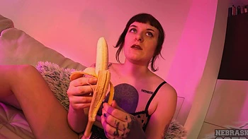 A hot brunette plays with a dildo on the sofa while masturbating solo.